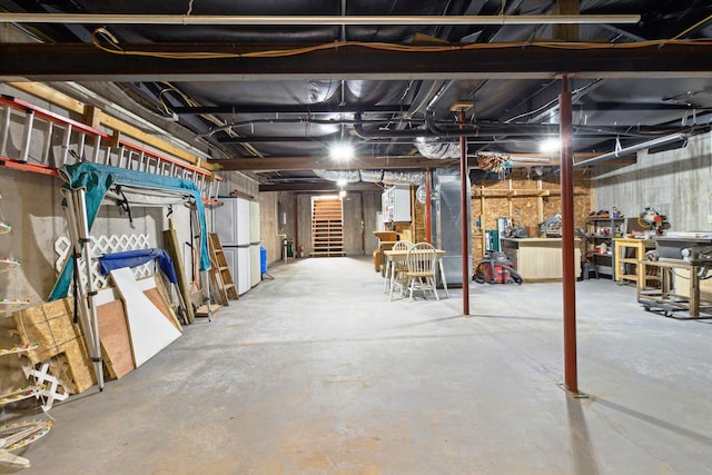 1797 Lawrence Dr, Bitely, MI 49309 - unfinished below grade area with stairs and freestanding refrigerator
