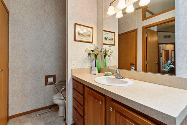 1797 Lawrence Dr, Bitely, MI 49309 - bathroom with toilet, vanity, and baseboards