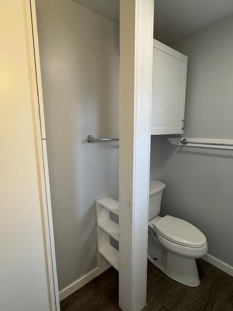 418 N Hemlock St, Evart, MI 49631 - bathroom with wood finished floors and toilet