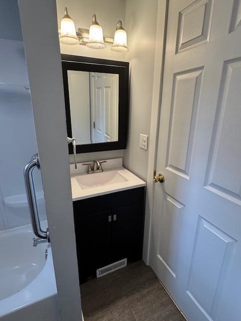 418 N Hemlock St, Evart, MI 49631 - full bathroom featuring vanity and tub / shower combination