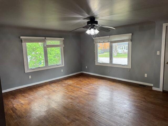 418 N Hemlock St, Evart, MI 49631 - spare room with a ceiling fan, baseboards, and wood finished floors