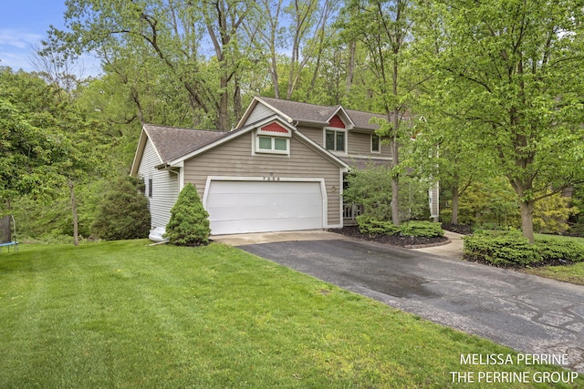 7359 Cascade Woods Dr SE, Grand Rapids, MI 49546 - view of front facade with a trampoline, asphalt driveway, a front yard, a garage, and a shingled roof