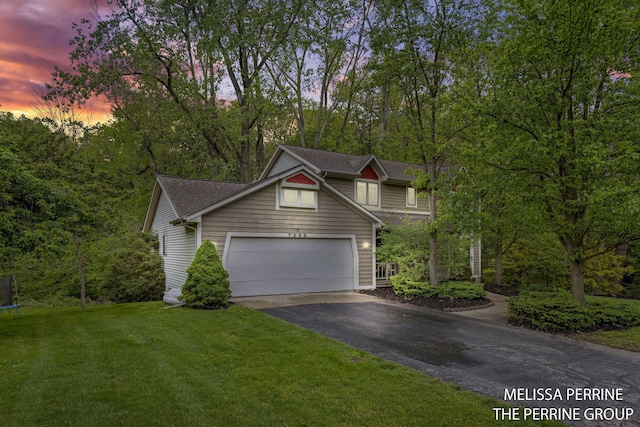 7359 Cascade Woods Dr SE, Grand Rapids, MI 49546 - view of front facade with a trampoline, asphalt driveway, a front lawn, an attached garage, and roof with shingles
