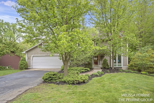 7359 Cascade Woods Dr SE, Grand Rapids, MI 49546 - obstructed view of property featuring asphalt driveway and a front yard