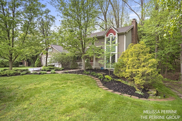 7359 Cascade Woods Dr SE, Grand Rapids, MI 49546 - view of front of property with a front lawn, a chimney, and a porch