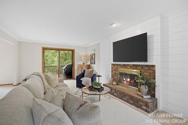7359 Cascade Woods Dr SE, Grand Rapids, MI 49546 - living area with wood finished floors, a brick fireplace, ornamental molding, and baseboards