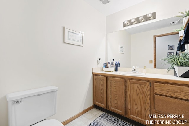 7359 Cascade Woods Dr SE, Grand Rapids, MI 49546 - bathroom with tile patterned flooring, toilet, vanity, and baseboards