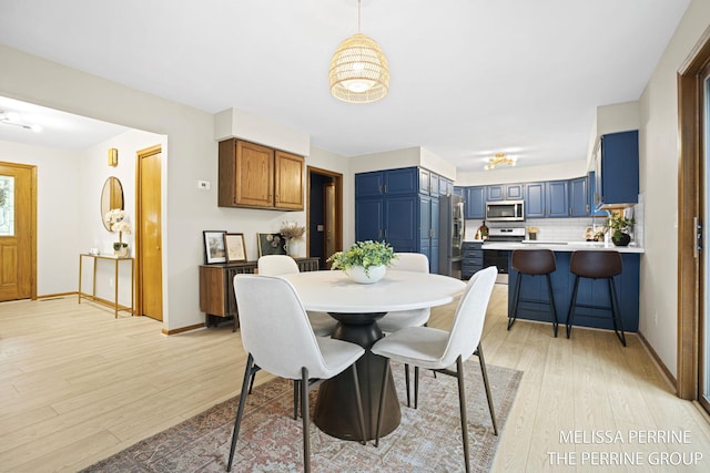 7359 Cascade Woods Dr SE, Grand Rapids, MI 49546 - dining area with light wood-style floors and baseboards