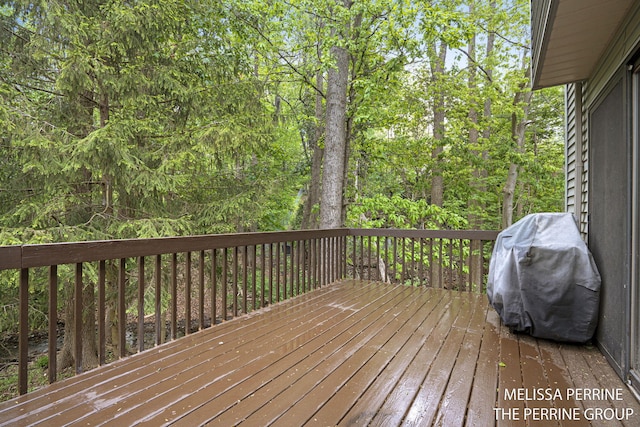 7359 Cascade Woods Dr SE, Grand Rapids, MI 49546 - wooden deck with a grill and a wooded view