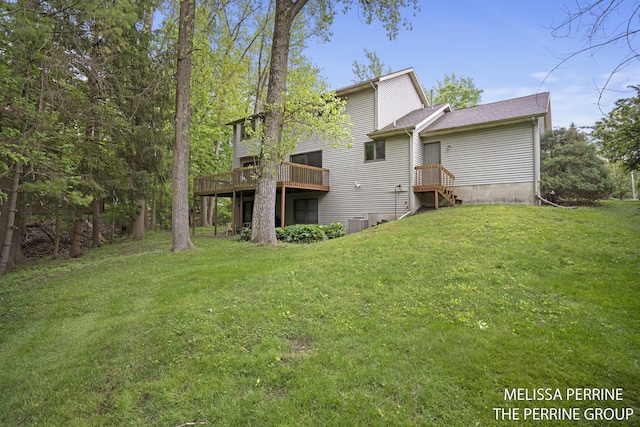 7359 Cascade Woods Dr SE, Grand Rapids, MI 49546 - rear view of house with a lawn and a deck