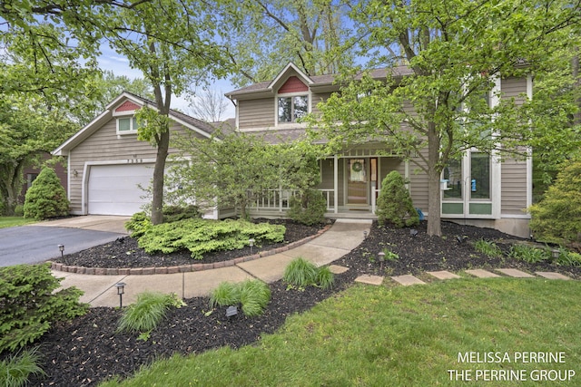 7359 Cascade Woods Dr SE, Grand Rapids, MI 49546 - view of front facade featuring covered porch and driveway