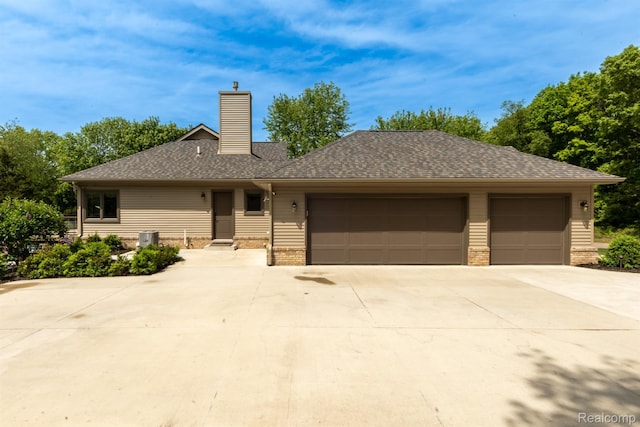 5502 E Alyssa Ct, White Lake, MI 48383 - single story home featuring a garage, concrete driveway, a chimney, and roof with shingles