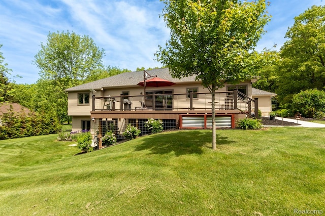 5502 E Alyssa Ct, White Lake, MI 48383 - rear view of property with a wooden deck, a lawn, and roof with shingles