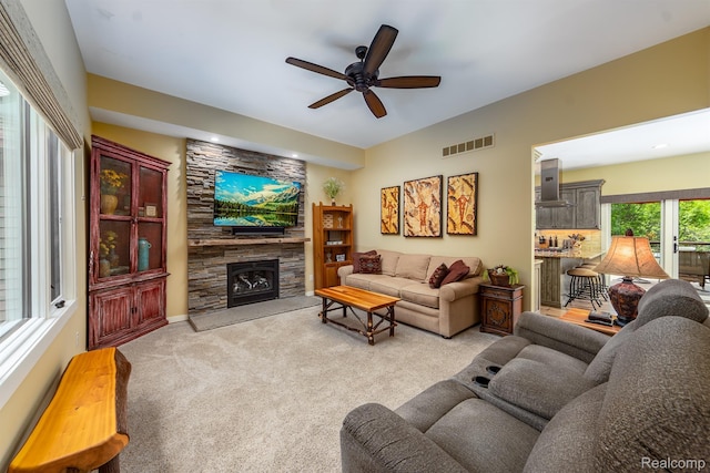 5502 E Alyssa Ct, White Lake, MI 48383 - carpeted living area featuring ceiling fan and a stone fireplace