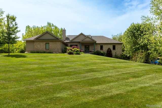 5502 E Alyssa Ct, White Lake, MI 48383 - view of front of house featuring a chimney, a front lawn, and brick siding