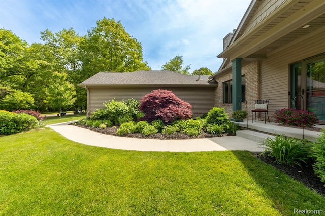5502 E Alyssa Ct, White Lake, MI 48383 - view of property exterior with brick siding, a lawn, and a chimney