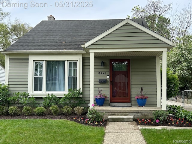 8441 Colgate St, Oak Park, MI 48237 - view of front of house with a porch, a shingled roof, and a chimney