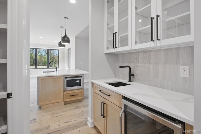 4030 Metamora Rdg, Metamora, MI 48455 - kitchen with beverage cooler, a sink, light brown cabinets, light wood finished floors, and recessed lighting