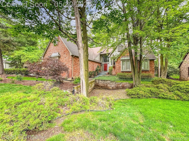 38836 Westchester Ln, Northville, MI 48167 - tudor home featuring brick siding and a front lawn