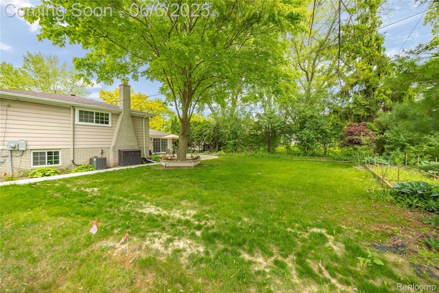 4118 Cherrywood Dr, Troy, MI 48098 - view of grassy yard featuring central air condition unit