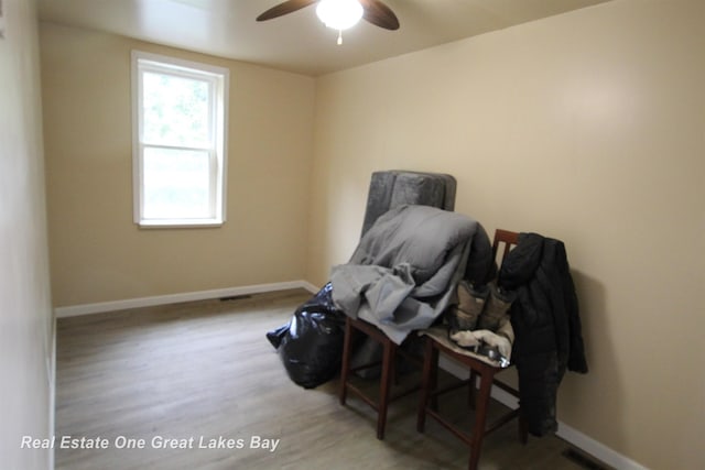 4141 Sagatoo Rd, Standish, MI 48658 - living area featuring ceiling fan, baseboards, and wood finished floors