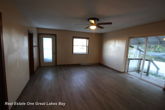 4141 Sagatoo Rd, Standish, MI 48658 - empty room featuring dark wood-type flooring, a ceiling fan, and baseboards