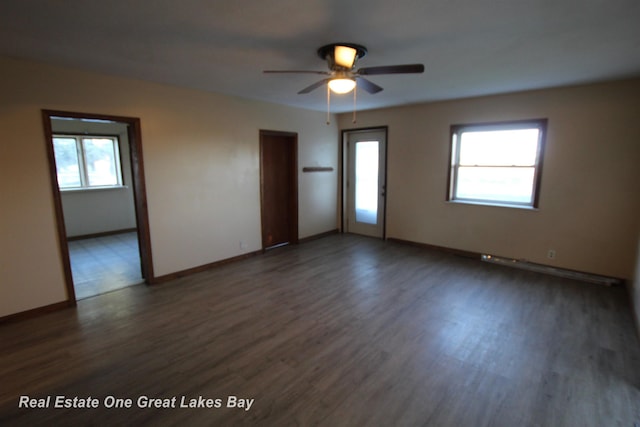 4141 Sagatoo Rd, Standish, MI 48658 - spare room with dark wood-style flooring, healthy amount of natural light, ceiling fan, and baseboards