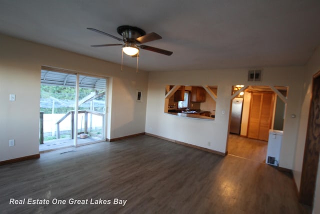 4141 Sagatoo Rd, Standish, MI 48658 - unfurnished living room featuring wood finished floors, baseboards, and ceiling fan