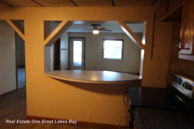 4141 Sagatoo Rd, Standish, MI 48658 - kitchen with electric stove, a peninsula, ceiling fan, and wood finished floors