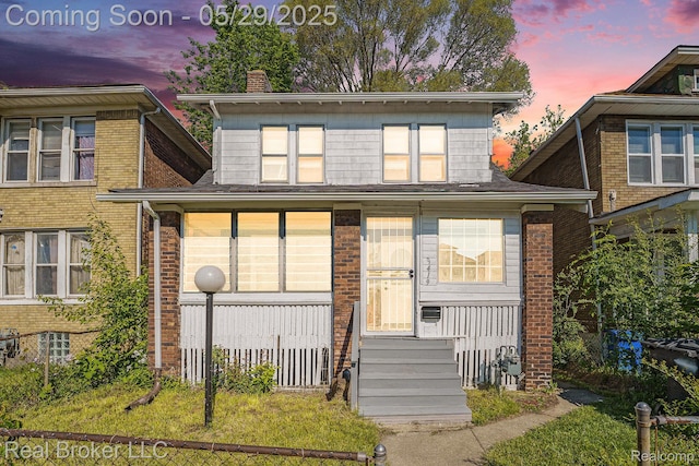 9419 Ravenswood St, Detroit, MI 48204 - view of front of house featuring a chimney, a porch, and brick siding