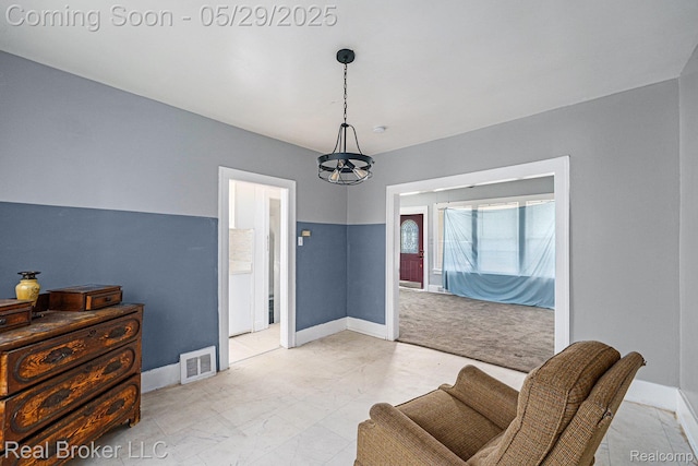 9419 Ravenswood St, Detroit, MI 48204 - sitting room featuring a chandelier, baseboards, and light marble finish floors