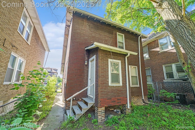 9419 Ravenswood St, Detroit, MI 48204 - view of property exterior with entry steps, central air condition unit, and brick siding