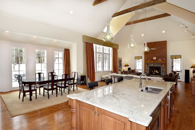 59 Scenic Oaks Dr S, Bloomfield Hills, MI 48304 - kitchen with a sink, beamed ceiling, a large fireplace, wood finished floors, and high vaulted ceiling