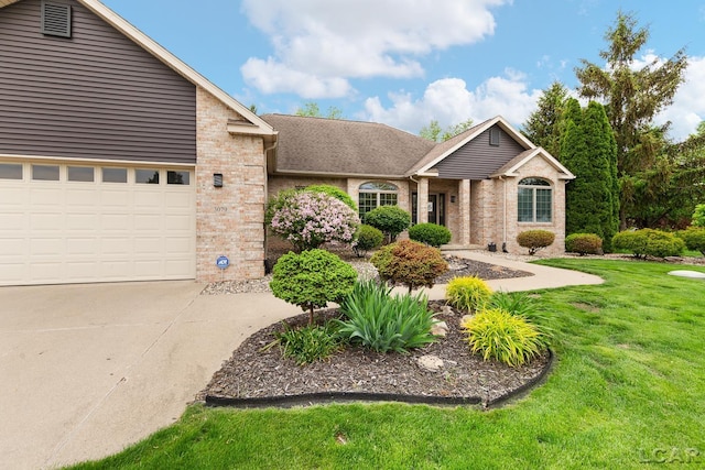3079 Windmill Ct, Adrian, MI 49221 - ranch-style house featuring brick siding, concrete driveway, a front lawn, and a garage