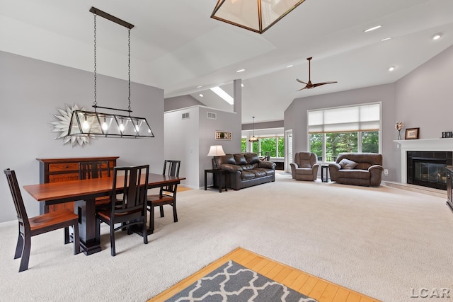 3079 Windmill Ct, Adrian, MI 49221 - dining area featuring high vaulted ceiling, ceiling fan, light carpet, a fireplace, and recessed lighting