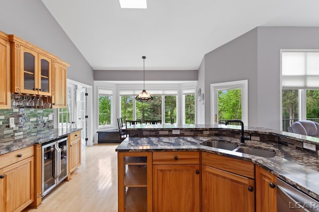3079 Windmill Ct, Adrian, MI 49221 - kitchen with a sink, beverage cooler, lofted ceiling, tasteful backsplash, and glass insert cabinets
