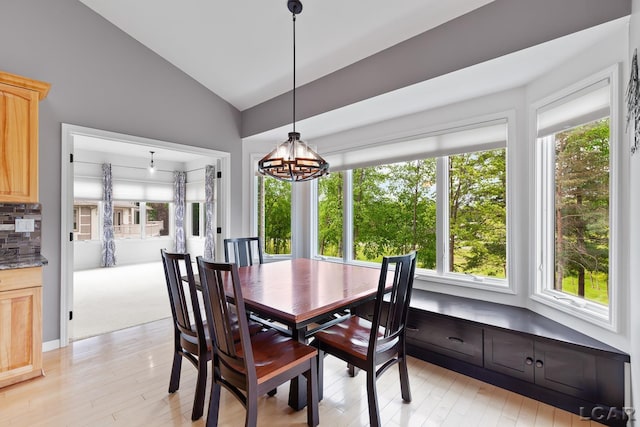 3079 Windmill Ct, Adrian, MI 49221 - dining room with vaulted ceiling, light wood-style floors, and a chandelier
