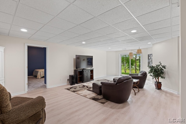 3079 Windmill Ct, Adrian, MI 49221 - living room with wood finished floors, a drop ceiling, baseboards, and recessed lighting