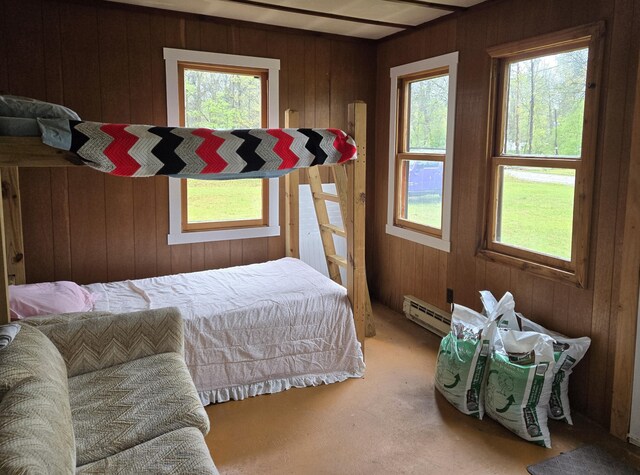 5282 N May Rd, Luther, MI 49656 - carpeted bedroom featuring baseboard heating and wood walls