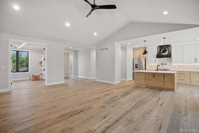 4075 Metamora Rdg, Metamora, MI 48455 - kitchen featuring premium range hood, open floor plan, stainless steel refrigerator with ice dispenser, a ceiling fan, and light brown cabinetry