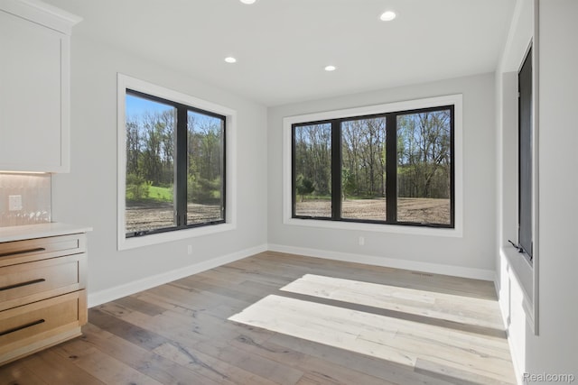 4075 Metamora Rdg, Metamora, MI 48455 - spare room featuring plenty of natural light, baseboards, light wood-style flooring, and recessed lighting