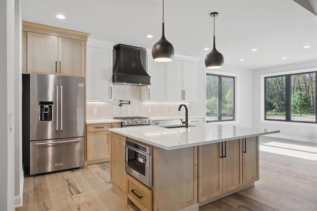4075 Metamora Rdg, Metamora, MI 48455 - kitchen with appliances with stainless steel finishes, custom range hood, a sink, light brown cabinetry, and light wood-style flooring