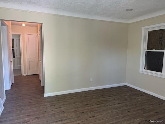 6106 Cadieux Rd, Detroit, MI 48224 - unfurnished room featuring dark wood finished floors, baseboards, a textured ceiling, and ornamental molding