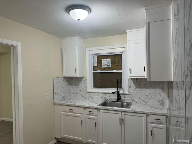 6106 Cadieux Rd, Detroit, MI 48224 - kitchen with a sink, tasteful backsplash, white cabinetry, and baseboards
