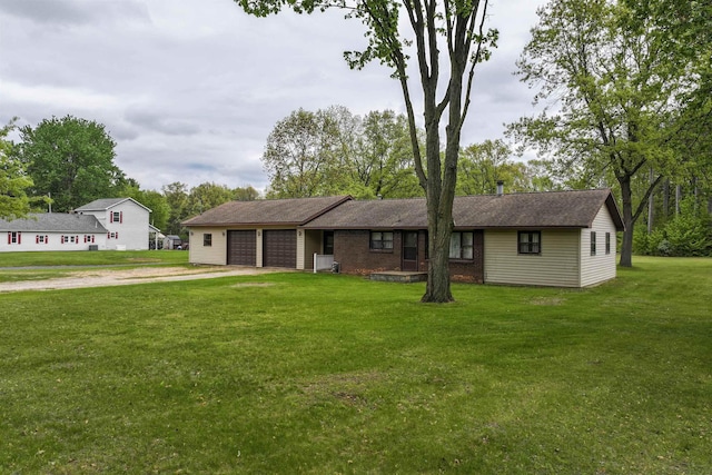 12310 Seymour Rd, Montrose, MI 48457 - view of front of house with driveway, a garage, and a front lawn