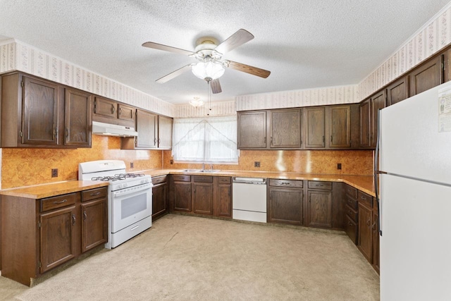 12310 Seymour Rd, Montrose, MI 48457 - kitchen featuring white appliances, under cabinet range hood, wallpapered walls, a textured ceiling, and light countertops