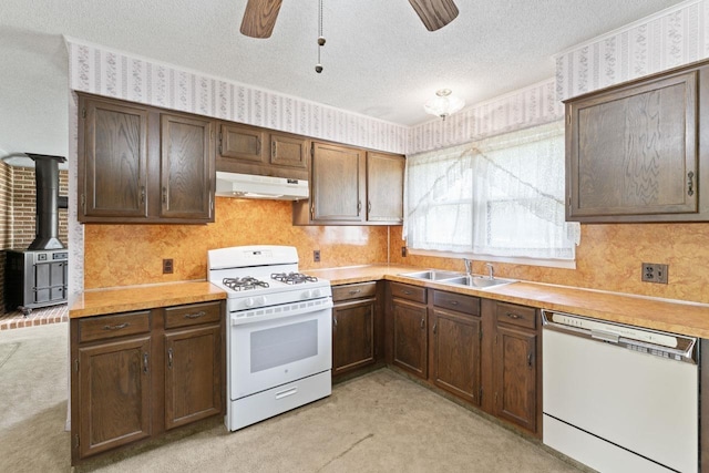 12310 Seymour Rd, Montrose, MI 48457 - kitchen with white appliances, a sink, ceiling fan, under cabinet range hood, and light carpet
