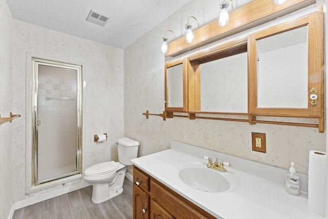 12310 Seymour Rd, Montrose, MI 48457 - full bath with wood finished floors, toilet, vanity, a shower stall, and wallpapered walls