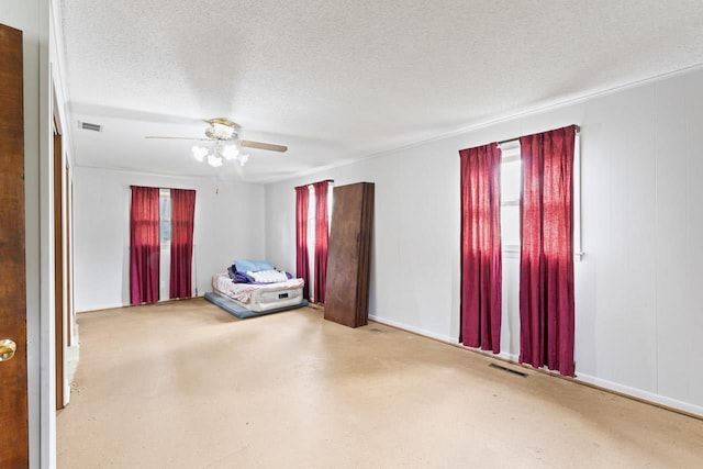 12310 Seymour Rd, Montrose, MI 48457 - unfurnished bedroom featuring ceiling fan, a textured ceiling, and baseboards