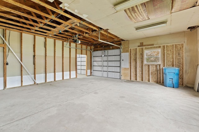 12310 Seymour Rd, Montrose, MI 48457 - garage featuring a garage door opener and electric panel